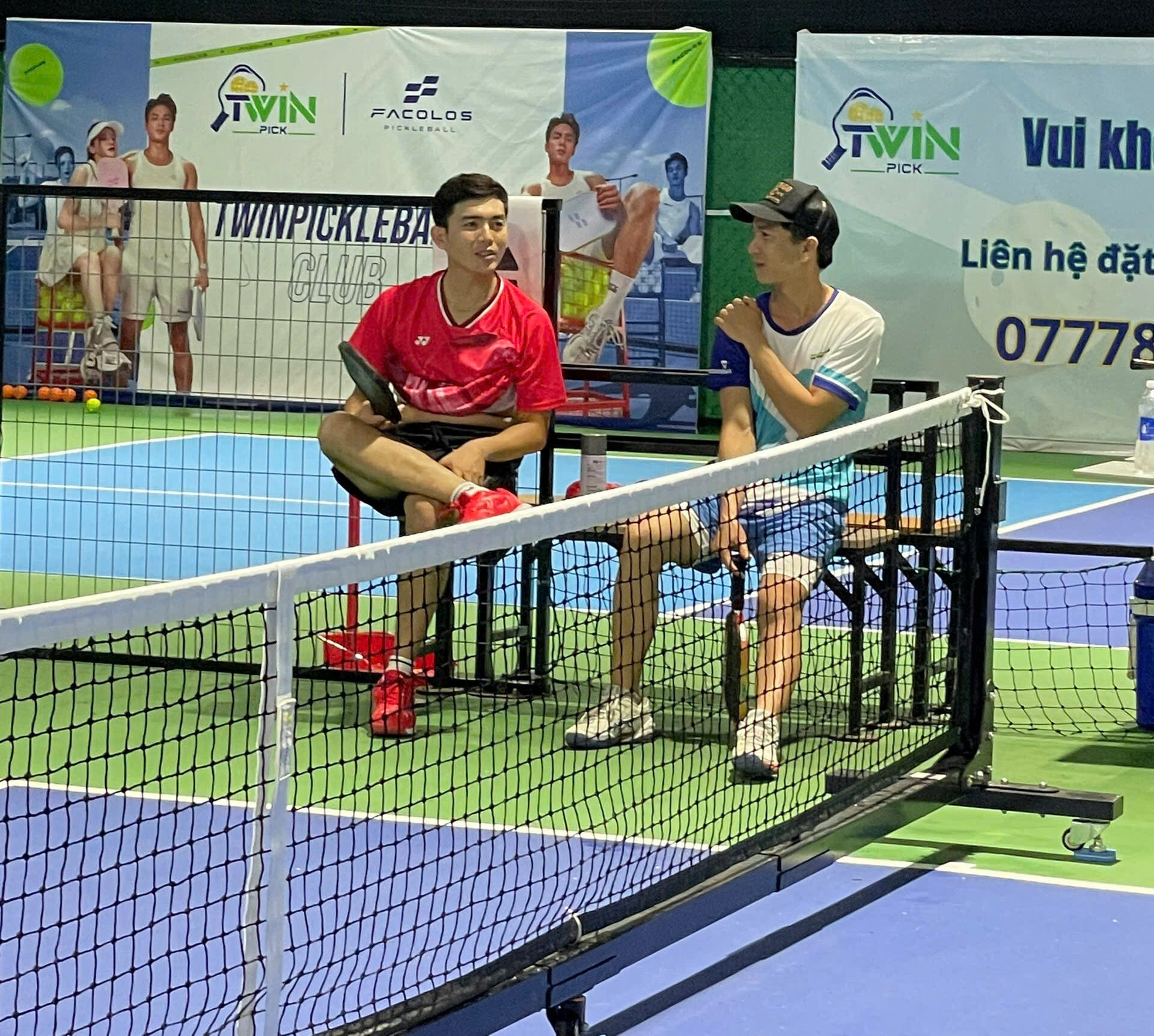 2 người chơi đang trò truyện vui vẻ với nhau sau trận đánh bóng